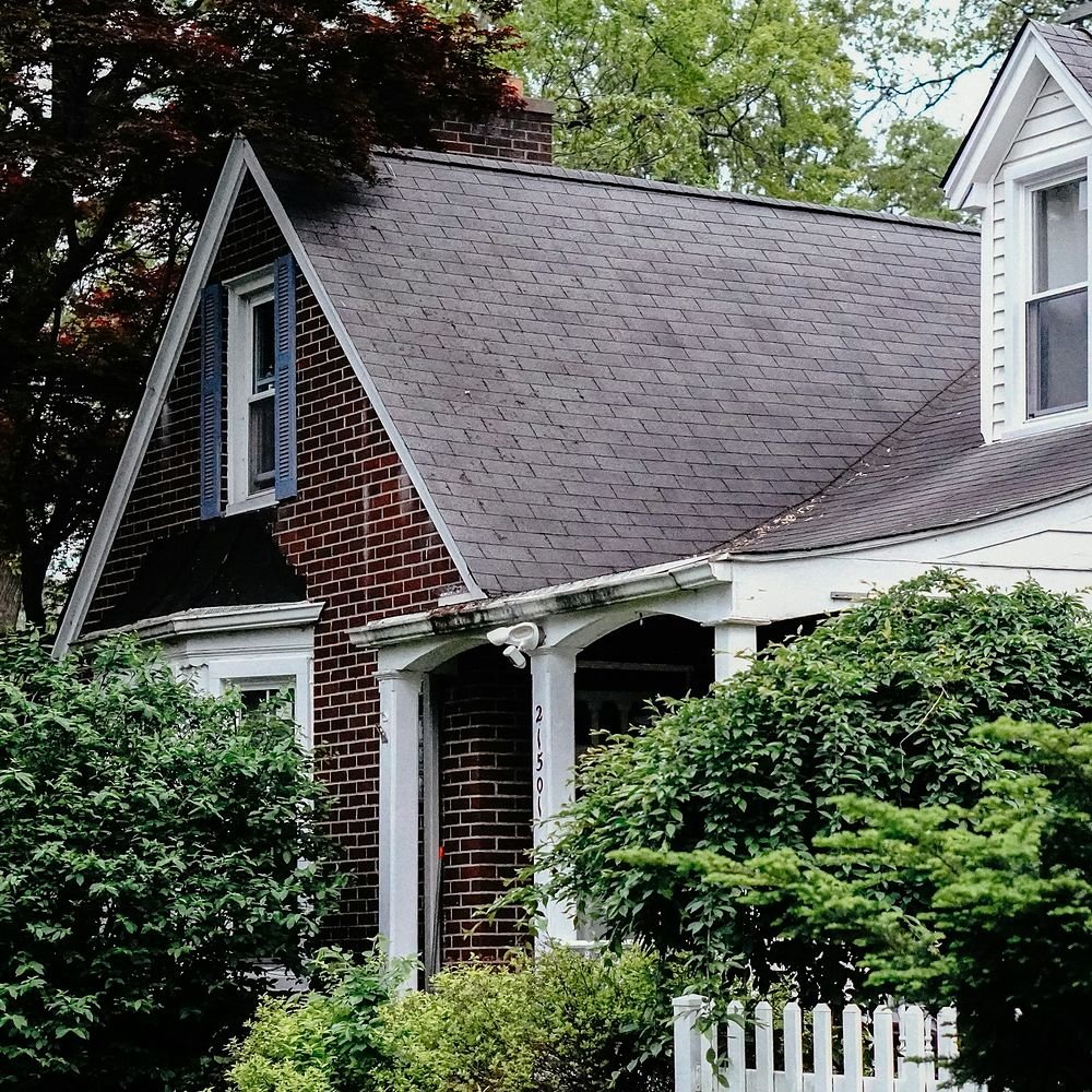 Home with an asphalt shingle roof and dormers